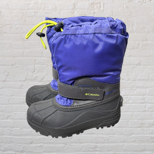 Columbia waterproof winter boots in purple and black with yellow drawcords, featuring a durable sole and warm lining.