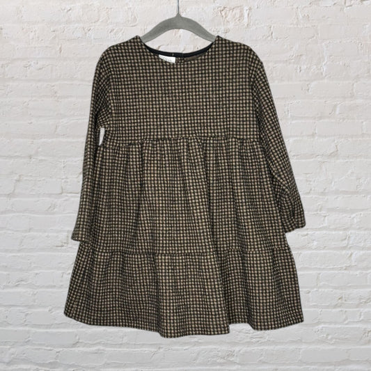 Brown and black checkered long sleeve dress with a loose, flowing silhouette displayed on a hanger.