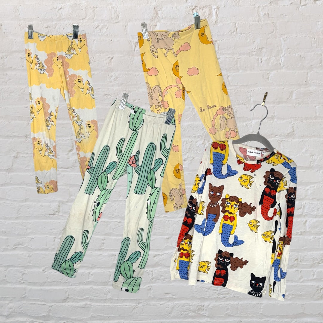Multicoloured kids sleepwear set with various graphic designs including mermaids, cacti, and whimsical creatures.