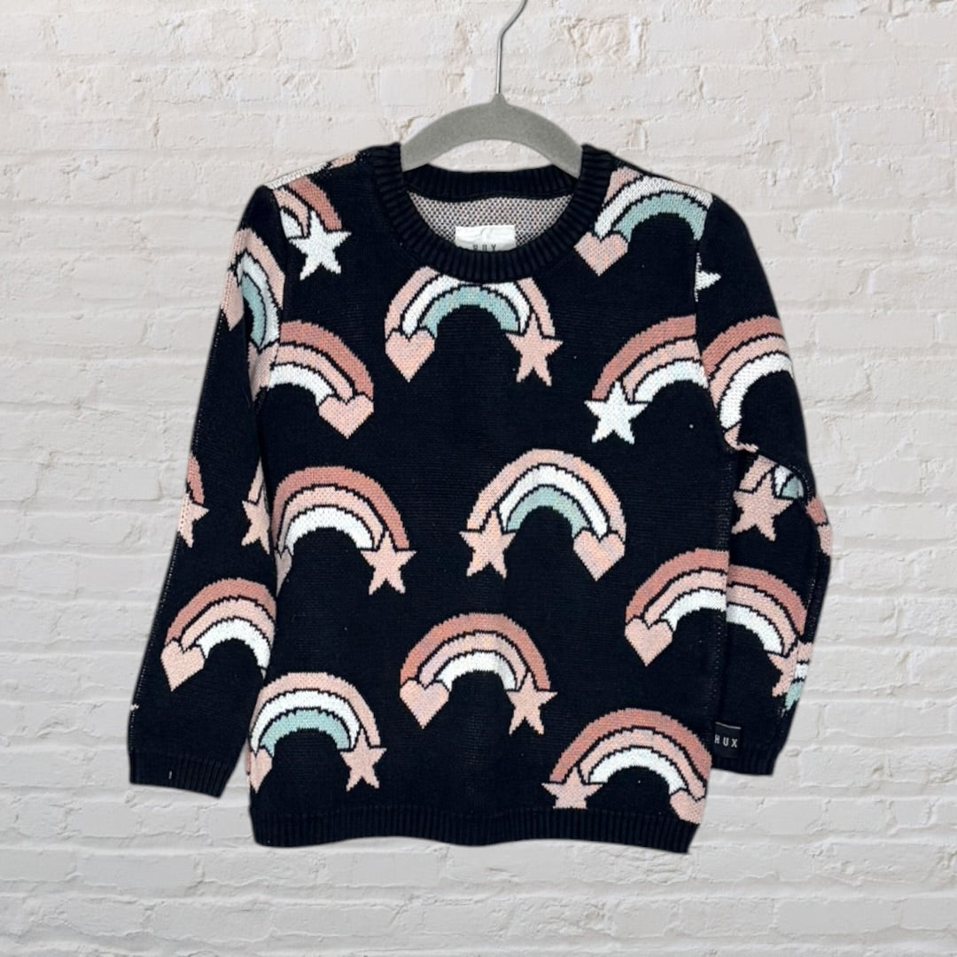 Navy sweater with pink and white rainbow and star patterns, displayed on a hanger.