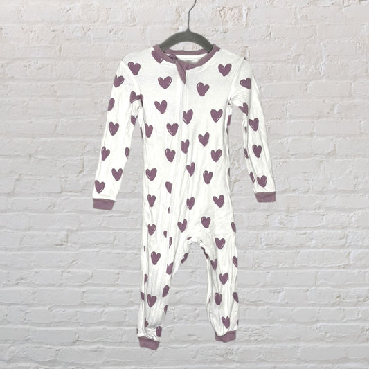 White footed onesie with purple heart prints, featuring long sleeves and a zipper front.