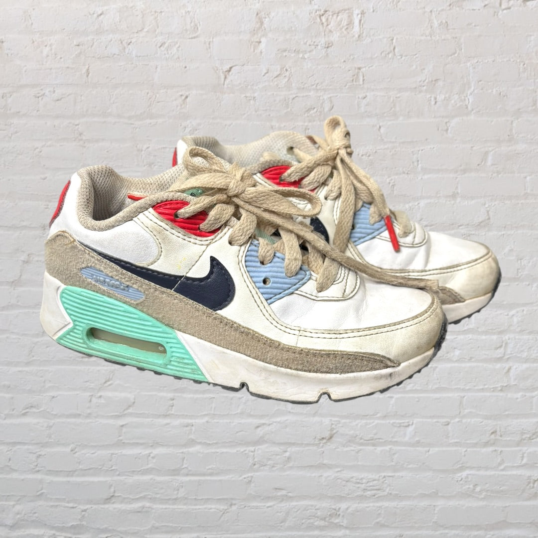 White sneakers with navy, red, and mint green accents, featuring a classic design with laces.