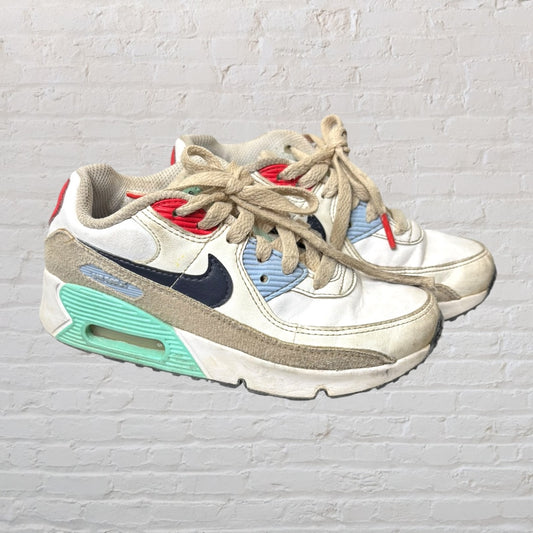 White sneakers with navy, red, and mint green accents, featuring a classic design with laces.