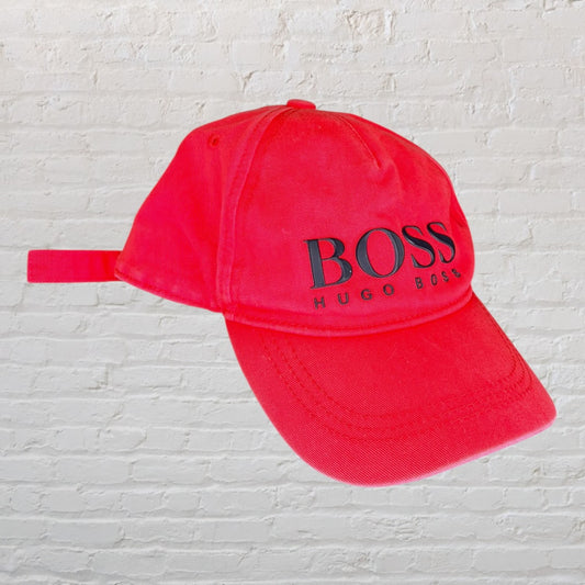 Red Hugo Boss baseball cap with black logo, featuring an adjustable strap.