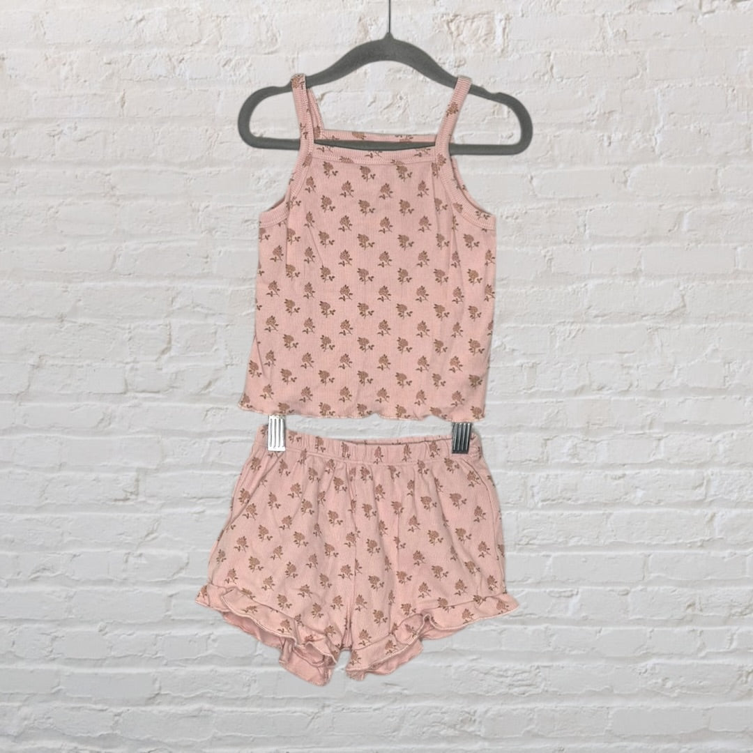 Pink floral print cami and shorts set with ruffle details, displayed on a hanger.