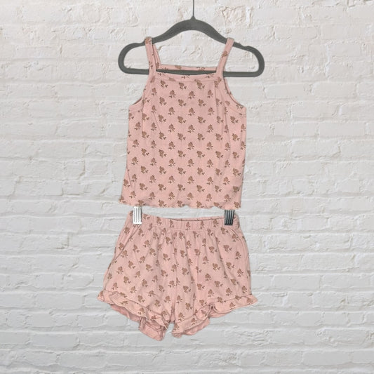 Pink floral print cami and shorts set with ruffle details, displayed on a hanger.