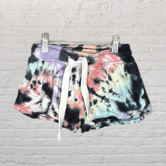 Multicolor tie-dye shorts with a white drawstring, featuring a casual design on a hanger.