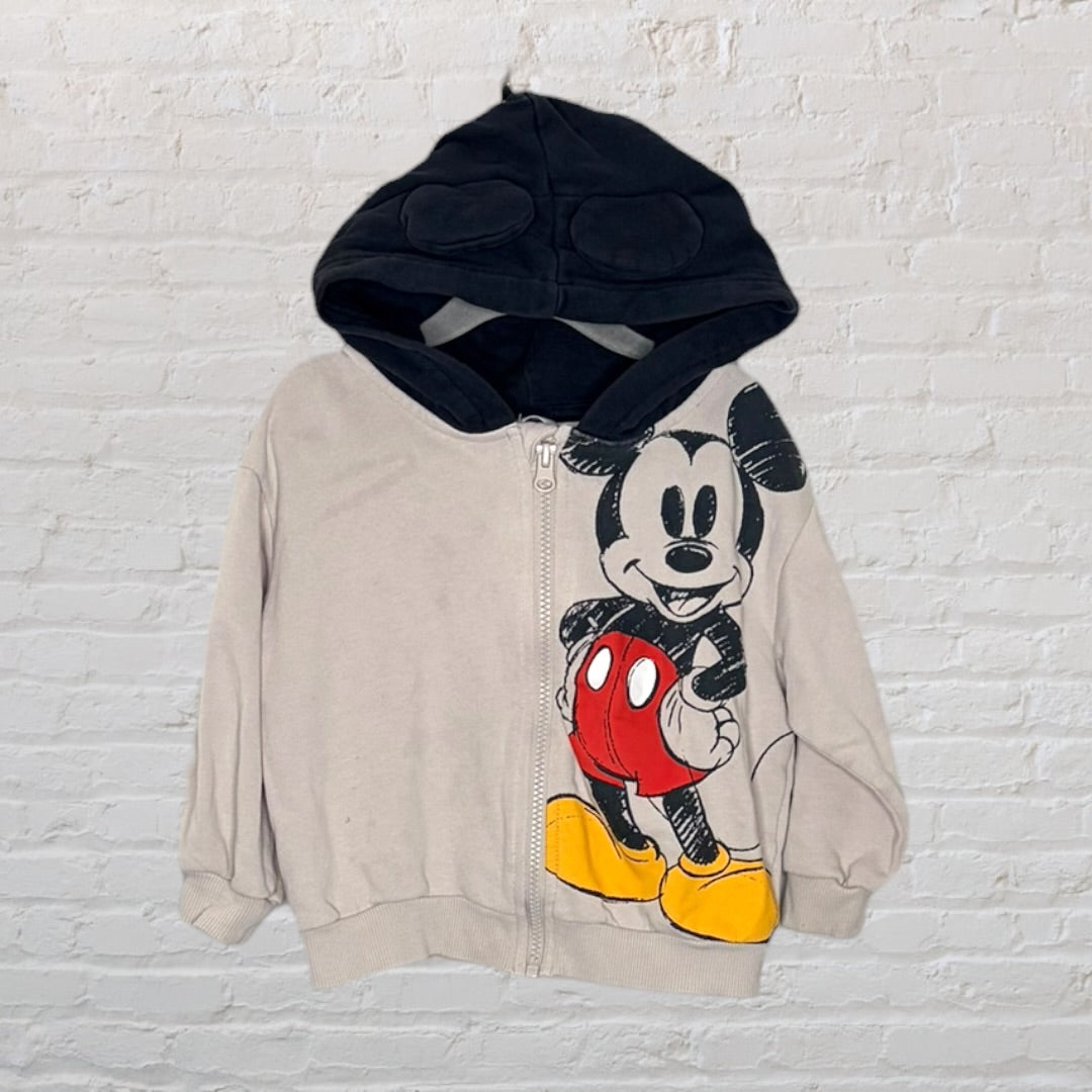 Beige zip-up hoodie with Mickey Mouse graphic and black hood with ears.