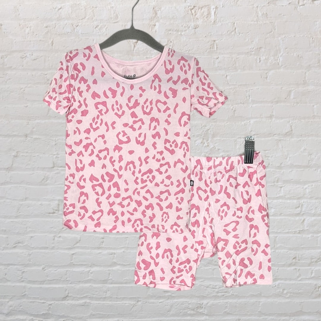 Pink leopard print pajama set with short sleeves and shorts, displayed on a hanger.