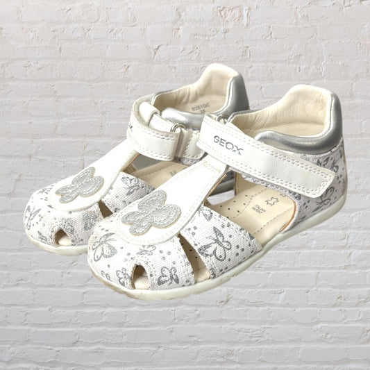 Children's white sandals with silver butterfly embellishments and adjustable straps by Geox.
