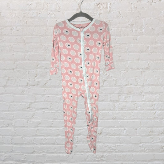 Pink baby onesie with fish pattern and full-length white zipper, hanging on a hanger.