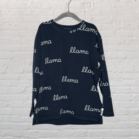 Navy long sleeve T-shirt with white 'llama' text print, by Tinycottons, hung on a hanger.