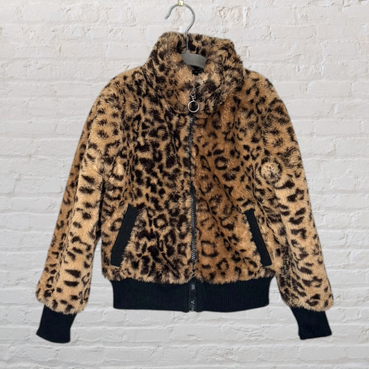 Women's leopard print faux fur jacket with black ribbed cuffs and hem, displayed on a hanger.