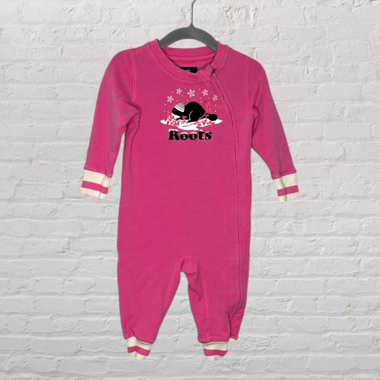 Pink Roots baby onesie with star and beaver graphic, long sleeves, and ribbed cuffs, hanging on a hanger.
