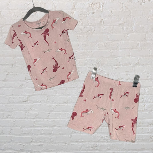 Light pink unisex pajama set featuring a playful shark and dolphin print, with a short-sleeve top and shorts.